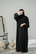 A lady wearing Black pleated and lace Abaya