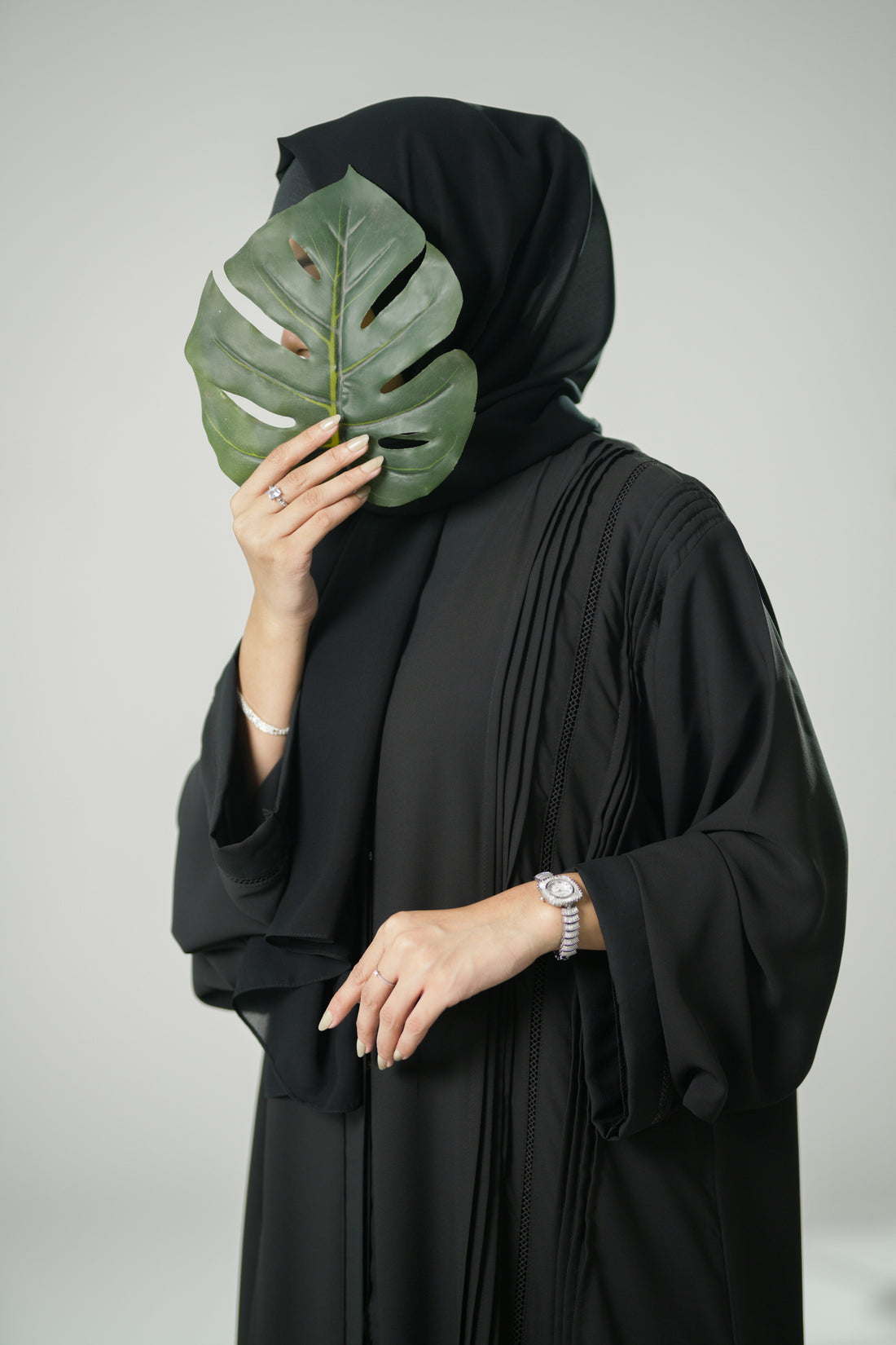 model wearing a black Pleated abaya with pleats