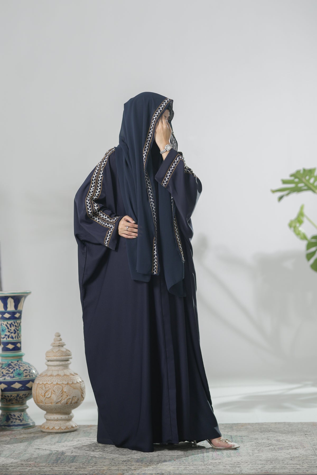 Navy Blue Abaya with Intricate Detailing on a White Background.